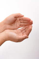 Two open hands are gently cupped together, palms facing upwards against a clean, white backdrop. The soft, natural light highlights the subtle details and curves of the hands.