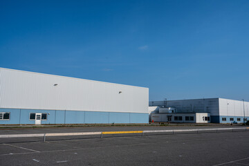 Fototapeta premium Two large white and blue warehouses.