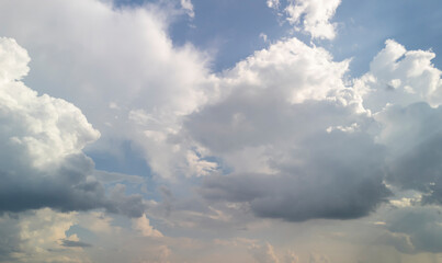 A stunning sky filled with soft, billowy clouds showcasing a blend of light and shadows. The tranquil scene evokes calmness and wonder.