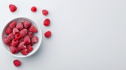 Fresh red raspberries in a white bowl on a light blue background, minimalistic fruit photography,...