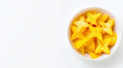 Bowl of star-shaped yellow fruit slices on a light blue background, flat lay fruit photography, creative fruit design, healthy and refreshing snack concept, minimalistic with copy space for text.

