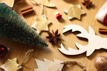 Various Christmas decorations in neutral colors on wooden background. Selective focus.