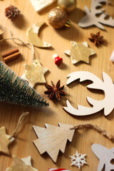 Various Christmas decorations in neutral colors on wooden background. Selective focus.