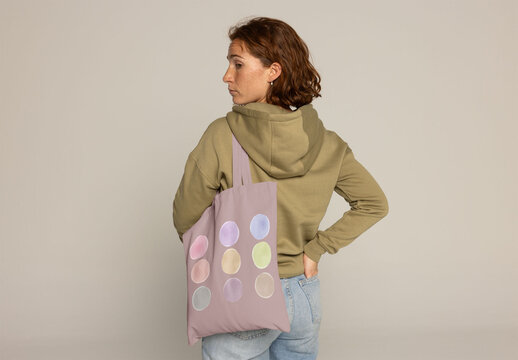 Customizable Tote Bag Held by Woman With Red Hair in Casual Setting. PSD mockup. Insert your design, your logo and change color from bag