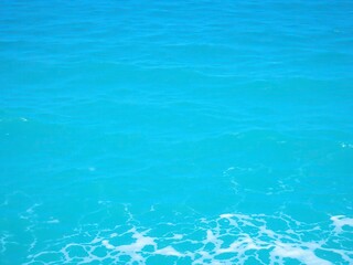 Obraz premium Pure blue turquoise water texture of the ocean sea with foam and waves, water, waves