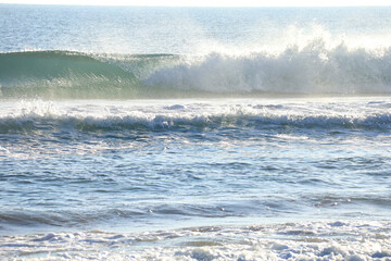 Waves breaking on the shore on the beach