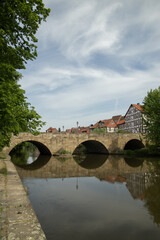 Bridge to The old Town of Bad Sooden Allendorf  against the backdrop of a beautiful blue sky with cirrus clouds in the Werra Valley, Germany. Vertical frame. High quality photo
