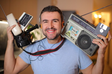 Man holding vintage technology items 