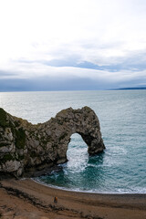 Durdle Door limestone arch on the Jurassic Coast in Dorset. Natural landmark. England. Pure clean clear water. Winter cold day at Durdle Door in Dorset, England, UK