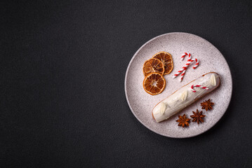 Sweet eclair with chocolate filling covered with white glaze