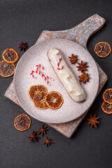 Sweet eclair with chocolate filling covered with white glaze