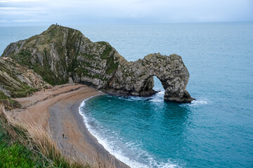 Durdle Door limestone arch on the Jurassic Coast in Dorset. Natural landmark. England. Pure clean clear water. Winter cold day at Durdle Door in Dorset, England, UK