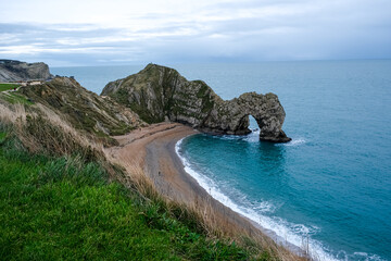 Durdle Door limestone arch on the Jurassic Coast in Dorset. Natural landmark. England. Pure clean clear water. Winter cold day at Durdle Door in Dorset, England, UK
