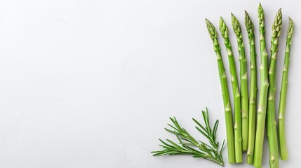 Fresh green asparagus spears with rosemary sprigs, flat lay food photography on a white background, minimalistic healthy eating concept, vegetarian design with copy space for text.

