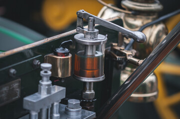 Glass oiler, oil feed, of a vintage, veteran car on a motor show in |Brighton, East Sussex, UK