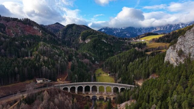 Drone footage of the Semmering railway in early December landscape, Austria, Europe. The landscape on former 20 schilling note bill.