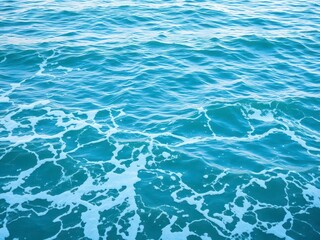 Obraz premium Smooth blue turquoise ocean water with white foamy waves crashing on the shore, background, sea
