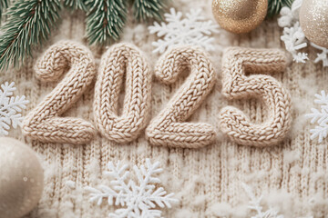 Close-up of the numbers 2025 knitted into a textured beige fabric with snowflake decorations