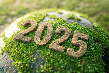The numbers 2025 crafted from soil and grass placed on a globe-shaped surface with greenery in the background