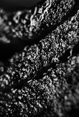 Textured black and gray surface with intricate patterns and depth