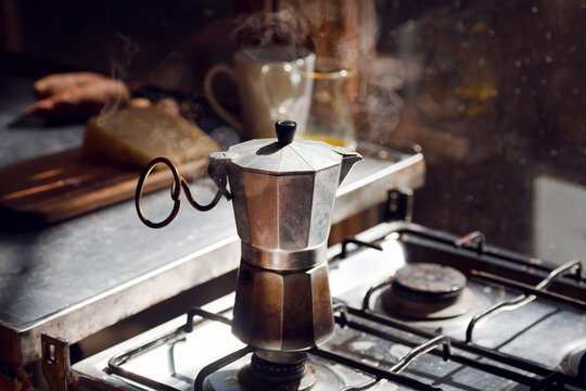 Italian vintage coffee cooker on hot stove of a village home. Breakfast still-life.