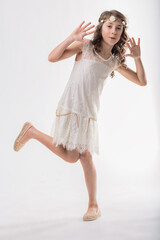 Young girl dancing and having fun in white dress