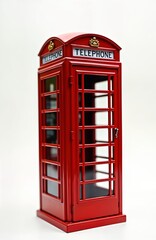 Miniature red telephone booth. Classic British design. Isolated on white background. Small iconic communication symbol. Vintage style. Attractive miniature. Historical telecom equipment. Tourism