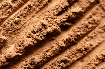 Close up of the texture of cocoa powder with diagonal lines. 
