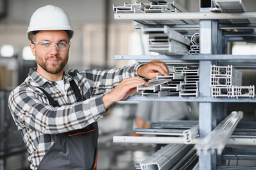 Factory worker. Man with helmet working with pvc