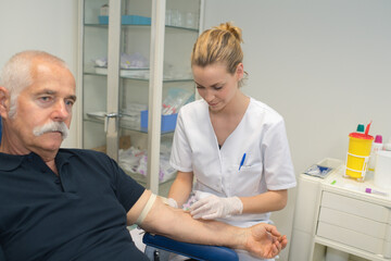 Fototapeta premium nurse is taking blood for test at the doctor office