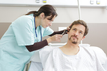 a doctor examining a patients ear