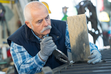 senior man working wotj checkerplate