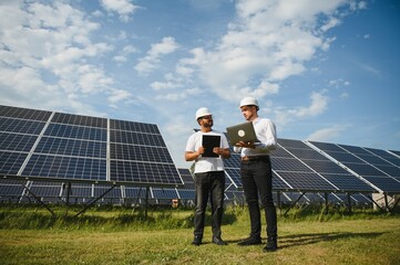 Indian engineer and businessman planing new ecology project. around solar panel