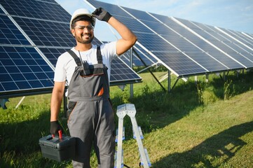 Indian worker installing solar panels. Concept of alternative, renewable energy