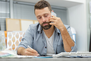 Fototapeta premium male worker talking to client on smartphone
