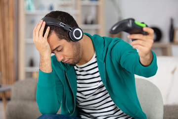 gamer holding gamepad has been defeated