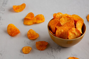 Homemade Flavored Paprika Potato Chips in a Bowl, side view.