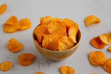 Homemade Flavored Paprika Potato Chips in a Bowl, side view.