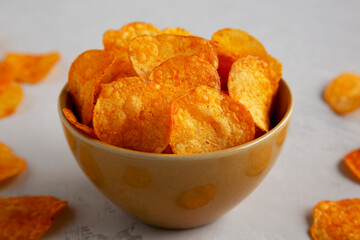 Homemade Flavored Paprika Potato Chips in a Bowl, side view. Close-up.