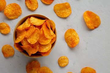 Homemade Flavored Paprika Potato Chips in a Bowl, top view. Flat lay, overhead, from above.