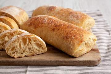 Homemade Sliced Ciabatta Bread on a wooden board, low angle view. Close-up.