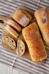 Homemade Sliced Ciabatta Bread on a wooden board, top view. Flat lay, overhead, from above.