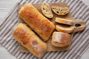 Homemade Sliced Ciabatta Bread on a wooden board, top view. Flat lay, overhead, from above.
