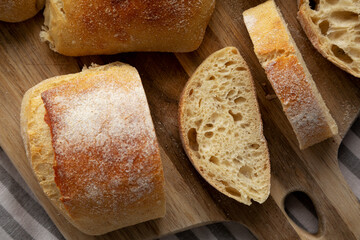 Homemade Sliced Ciabatta Bread on a wooden board, top view. Flat lay, overhead, from above. Close-up.