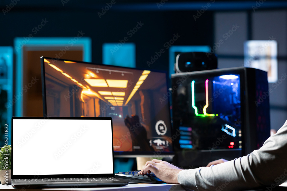 Poster man sitting on gaming chair using mockup laptop, relaxing by playing videogame on pc at computer des