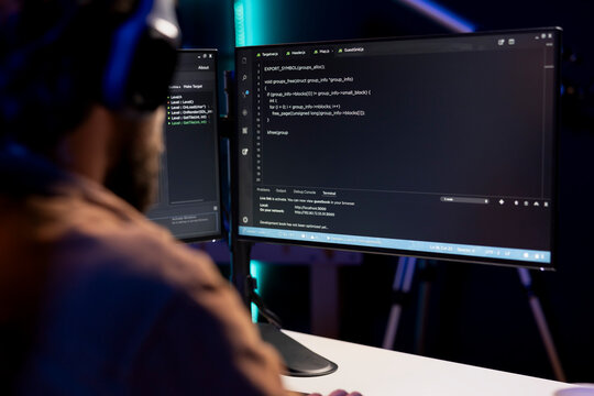 Programmer writing code on computer to futureproof company network from downtimes and unexpected system failures. Man deploying programming script increasing data security