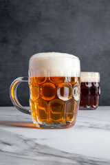 Delicious Pale Ale and Amber Ale Beer Drinks with Large Foam Heads in Traditional and Classic Glasses