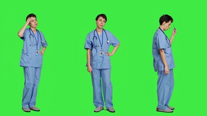 Medical assistant thinking about new treatment ideas in studio, acting thoughtful while she stands against greenscreen backdrop. Pensive young nurse contemplating about healthcare ideas. Camera A.