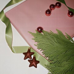 A festive holiday composition featuring red Christmas ornaments