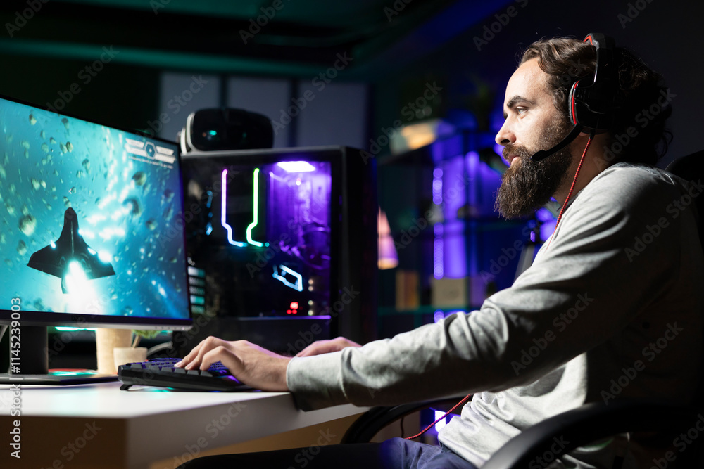 Poster man using gaming keyboard and headphones to play spaceship flying game with overlay hud showing heal